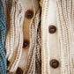 Nui Organics Women's Bernard Cardigan — close-up of corozo nut buttons across multiple colourways including Deep Sea, Oatmeal and Natural
