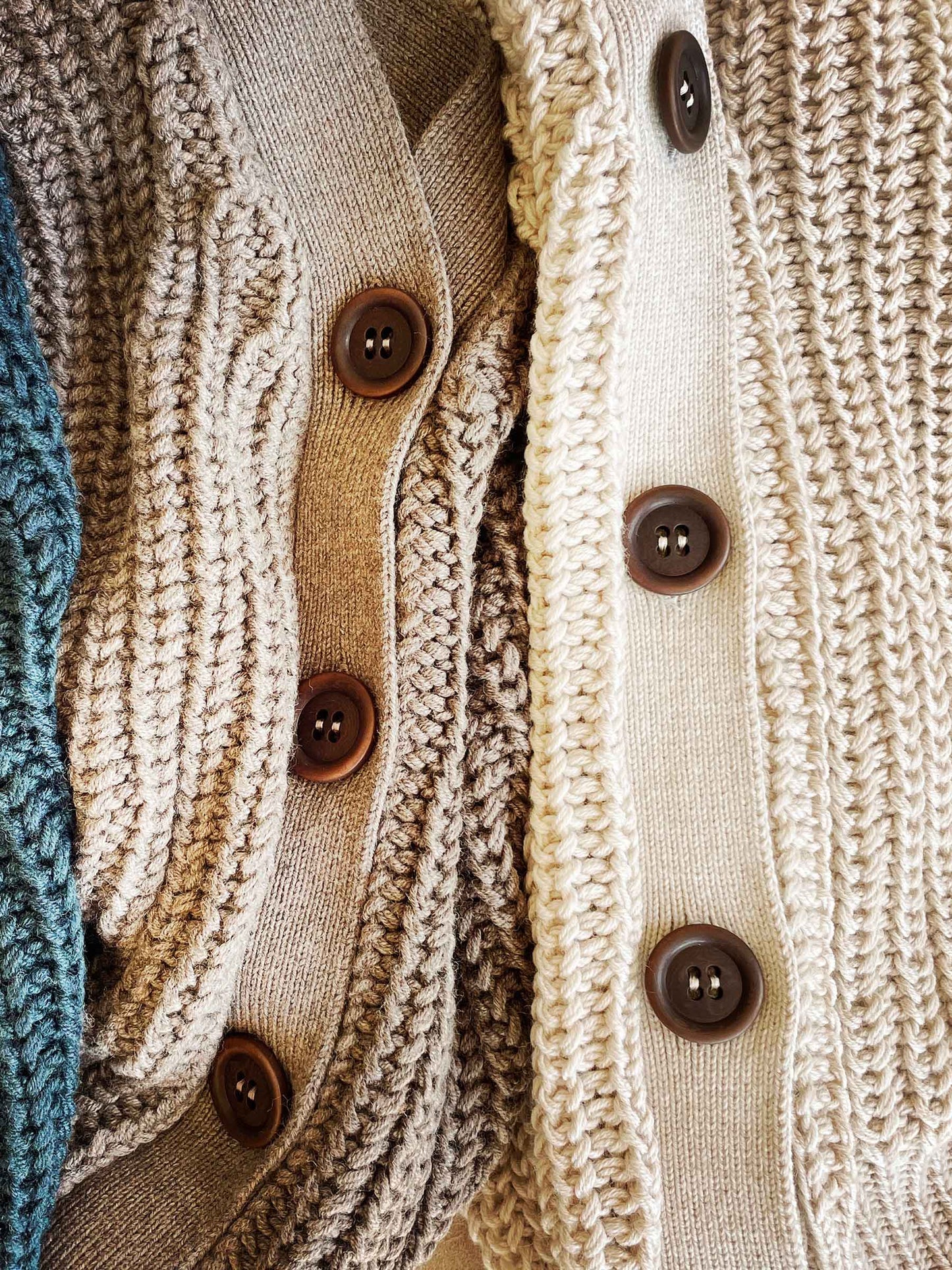 Nui Organics Women's Bernard Cardigan — close-up of corozo nut buttons across multiple colourways including Deep Sea, Oatmeal and Natural