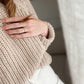 Nui Organics Women's Fishline Sweater in Oatmeal — close-up of chunky merino knit texture and ribbed cuff detail