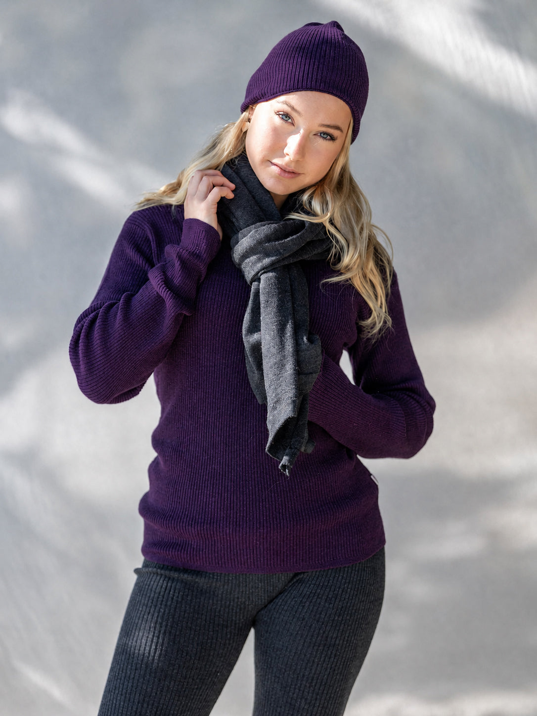 Nui Organics Women's Hopu Top in Plum — woman in plum rib knit merino top and beanie styled with a charcoal merino scarf