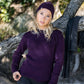 Nui Organics Women's Hopu Top in Plum — woman in plum rib knit merino top and beanie with charcoal leggings outdoors by a tree